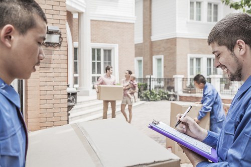 Moving team separating recyclable packing materials at a London property