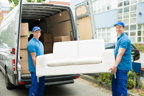 Removal team handling house move logistics in a London residential street
