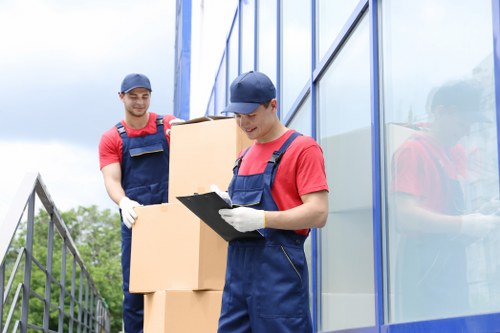 Professional movers beginning a London relocation with boxes and furniture