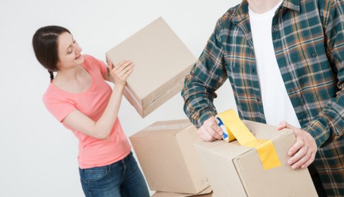 Professional movers handling a flat move in London with stairs and narrow access