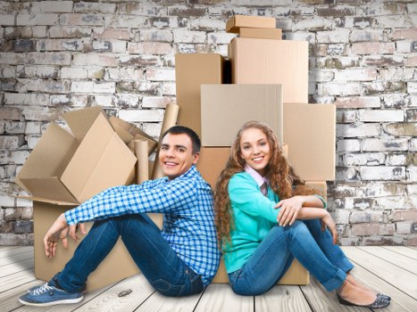Packed boxes and furniture ready for house removals in a London home