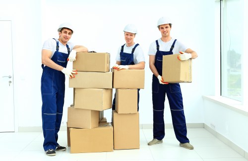 Workers using safe manual handling techniques with furniture