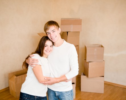Professional movers carrying furniture through a London apartment building