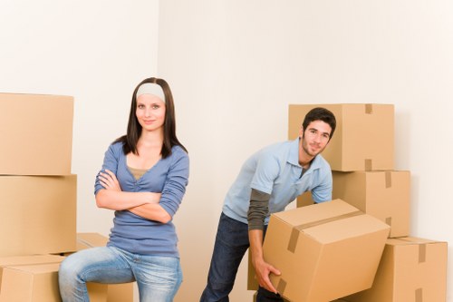Packed boxes and furniture ready for transport by moving truck in London