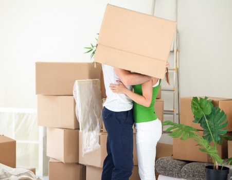Local movers organising fragile household items for transport