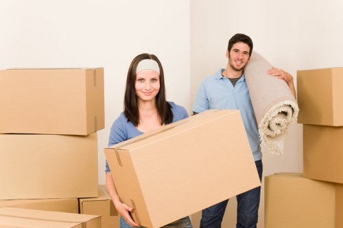 Local removals team carrying furniture in a London property