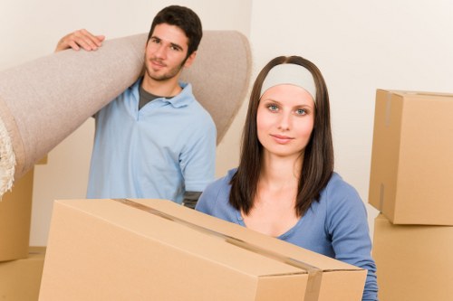 Professional movers loading a van outside a London flat